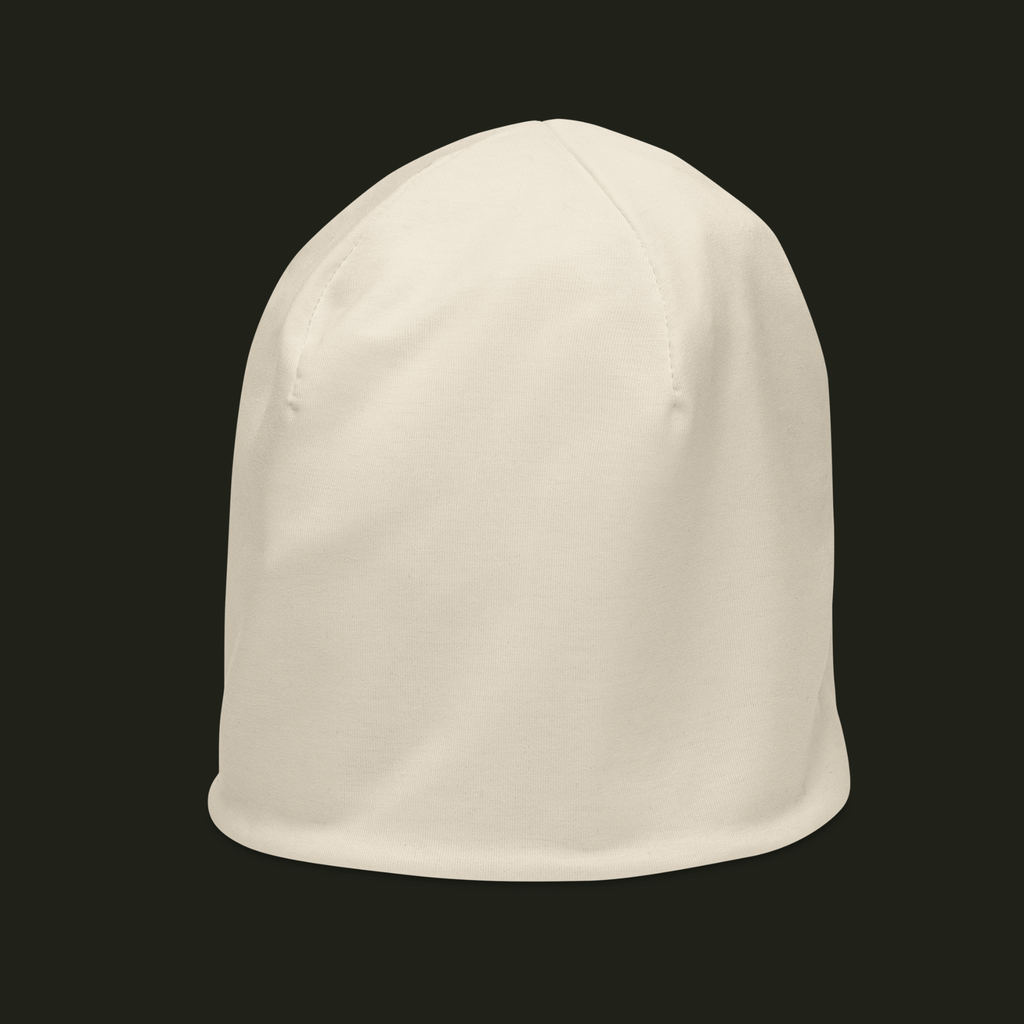 Elqavyn unisex beanie in a soft warm cream tone, shown from the left front with curved crown seams and a smooth finish.