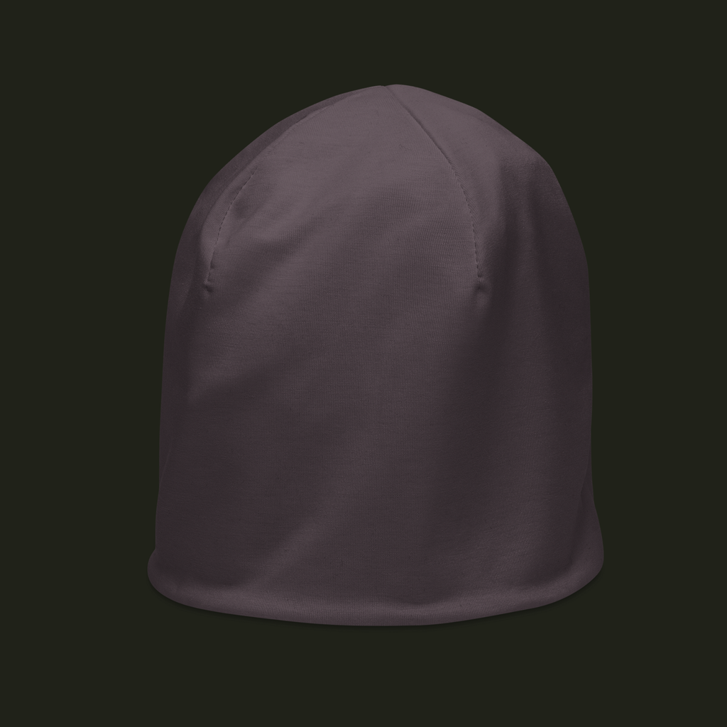 Myrqalen unisex beanie in a muted mauve taupe tone, shown from the left front with curved crown seams and a smooth finish.