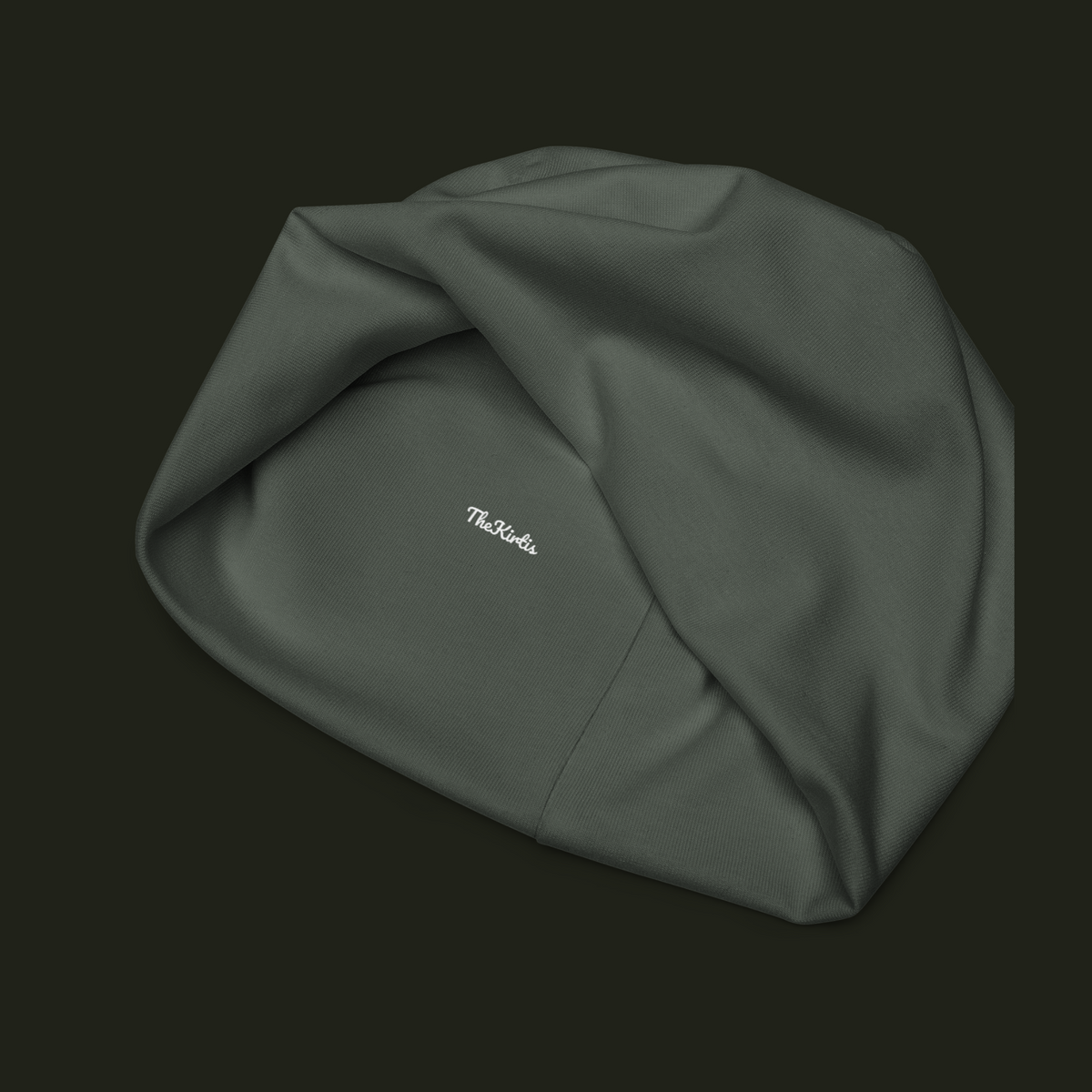 Inside view of the Nalqevyn unisex beanie showing the TheKirtis label, muted olive grey fabric texture and interior seam construction.