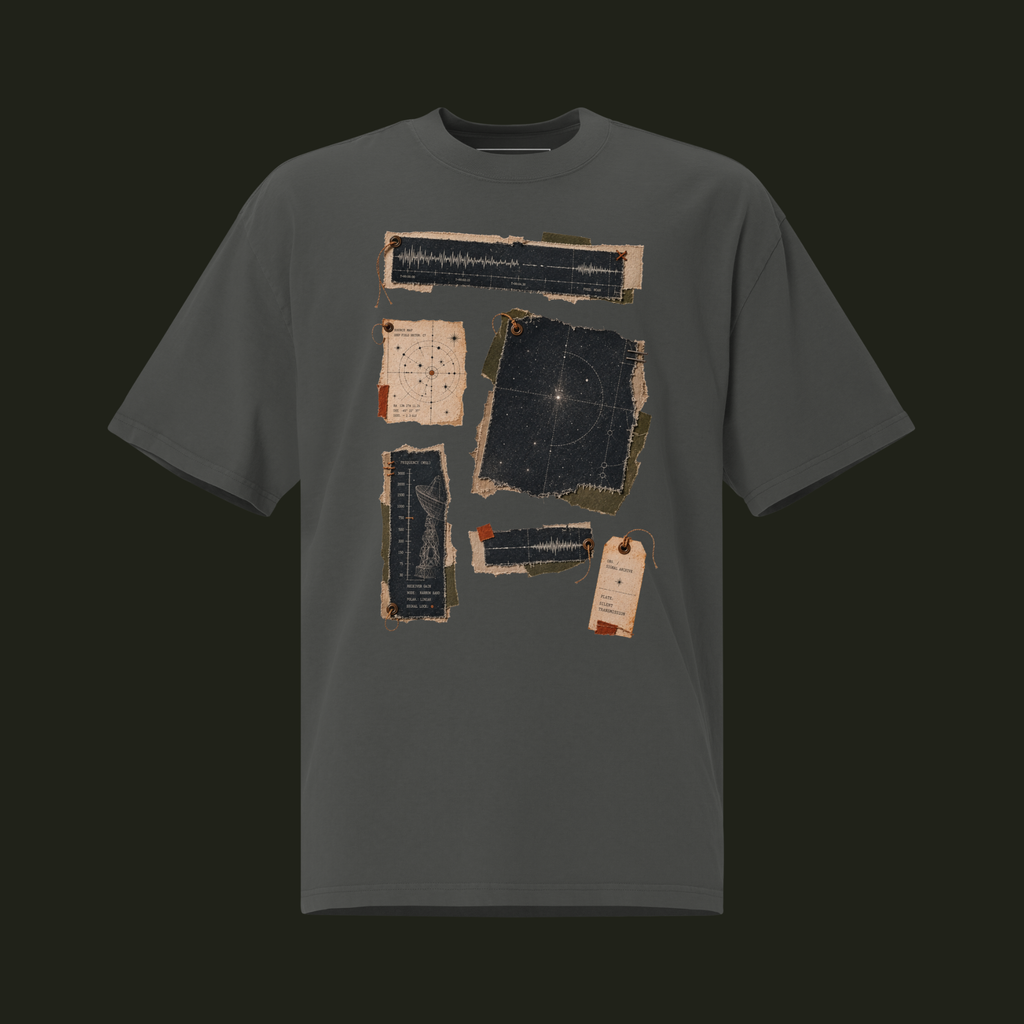 Faded Coal unisex oversized graphic T-shirt featuring the Silent Transmission cosmic patchwork design with signal waveforms, a star map and transmission charts.